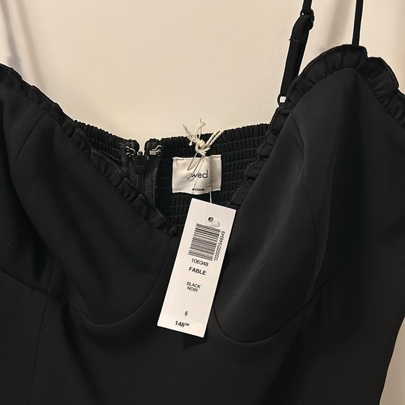 This is a jumpsuit with a lined bodice, sweetheart neckline with a ruffled trim. - Picture 4 of 5